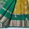 Semi Kanchi Pattu Handloom Saree in Olive Gold with Emerald Green Peacock Zari Border Semi Kanchi Pattu Handloom Saree Olive Gold & Emerald Green with Peacock Zari Border | Traditional Silk Saree